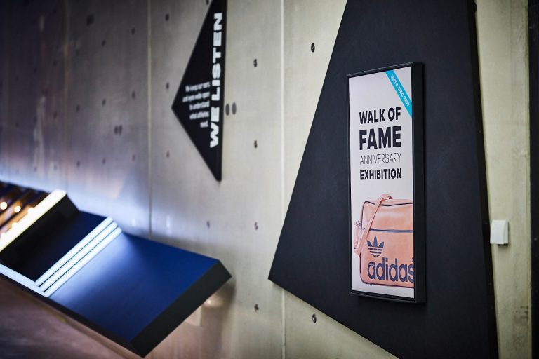 Adidas "Walk of Fame Anniversary Exhibition" - exhibition space with "WE LISTEN" wall installation and product display